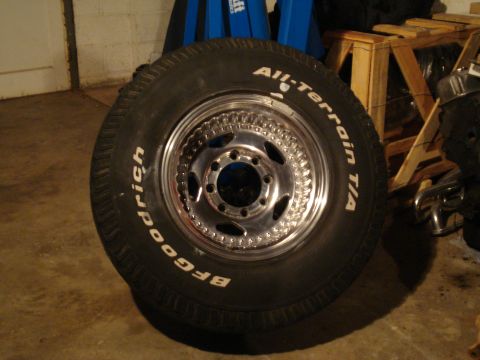 1967 Ford F-250 - A close-up of a BFGoodrich All-Terrain T/A tire mounted on a shiny chrome wheel.