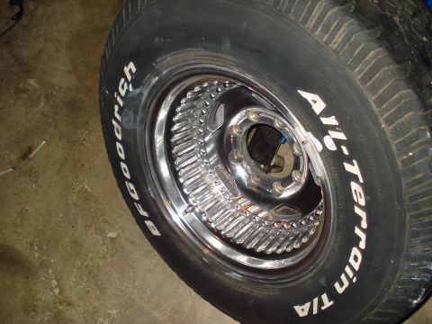 1967 Ford F-250 - A close-up view of a tire and wheel assembly, showing the tread pattern and chrome rim details.