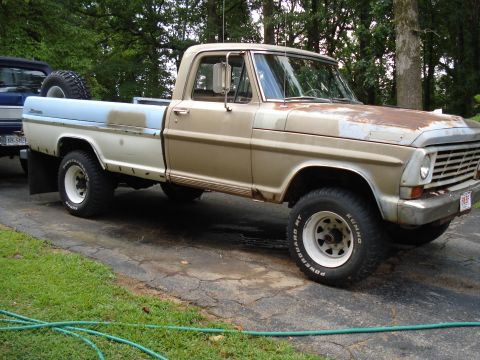 1967 Ford F-250 - This 1967 Ford F-250 pickup truck is seen from a 3/4 front angle, showing its two-tone paint and spare tire.