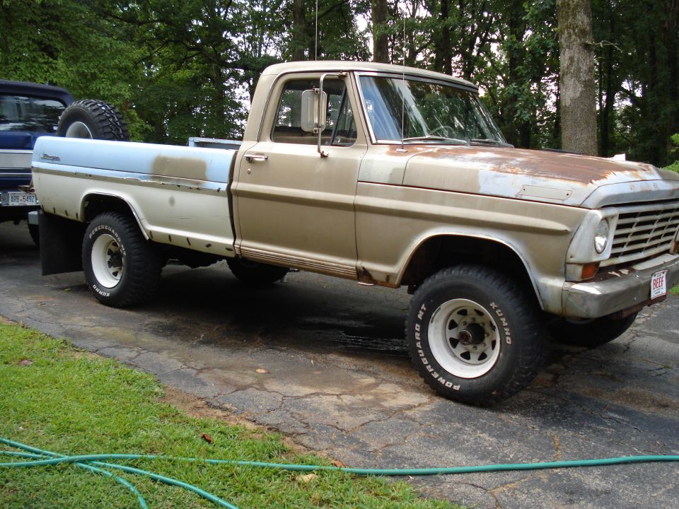 1967 Ford F-250 pickup truck, tan and white, with spare tire in bed