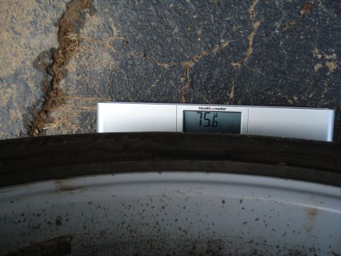 1967 Ford F-250 - A tire is weighed on a Health o meter scale, displaying 75.6 pounds.