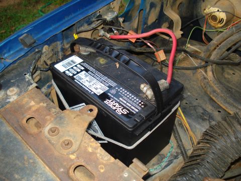 1967 Ford F-250 - A Super Start battery is installed in the engine compartment of a vehicle.