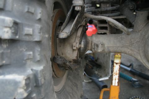 1987 Suzuki Samurai - Detail of the rear suspension and axle assembly of an off-road vehicle.