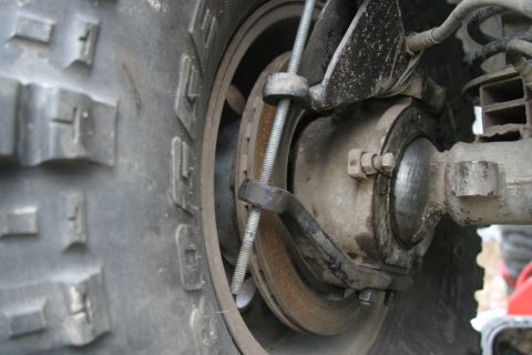 1987 Suzuki Samurai - Detail shot of a vehicle's brake system and tire.