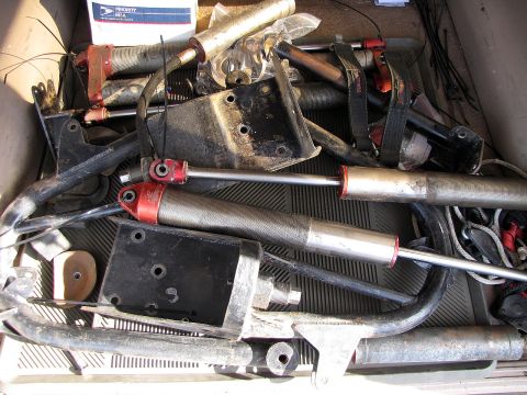 1984 Ford Bronco - A collection of assorted front suspension components, likely for an off-road vehicle, are piled together.