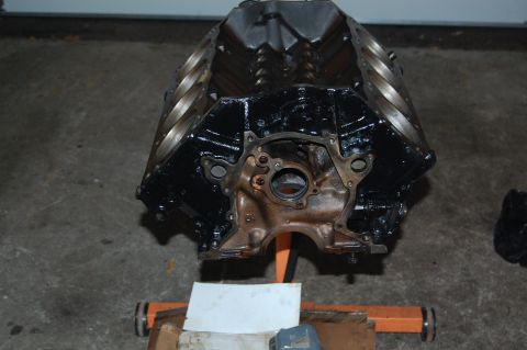 1994 Ford Bronco - A black engine block is shown mounted on an orange engine stand.