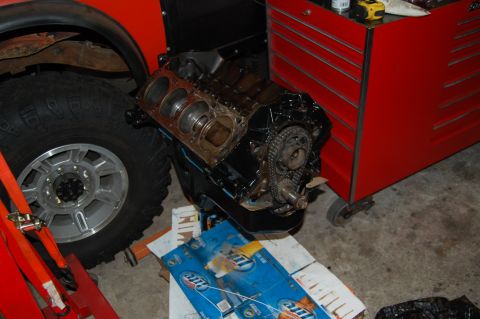 1994 Ford Bronco - Engine block and tire in a garage setting with a red toolbox visible.