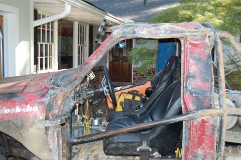 1994 Ford Bronco - Interior view of a heavily modified off-road vehicle with a prominent roll cage and racing seats.