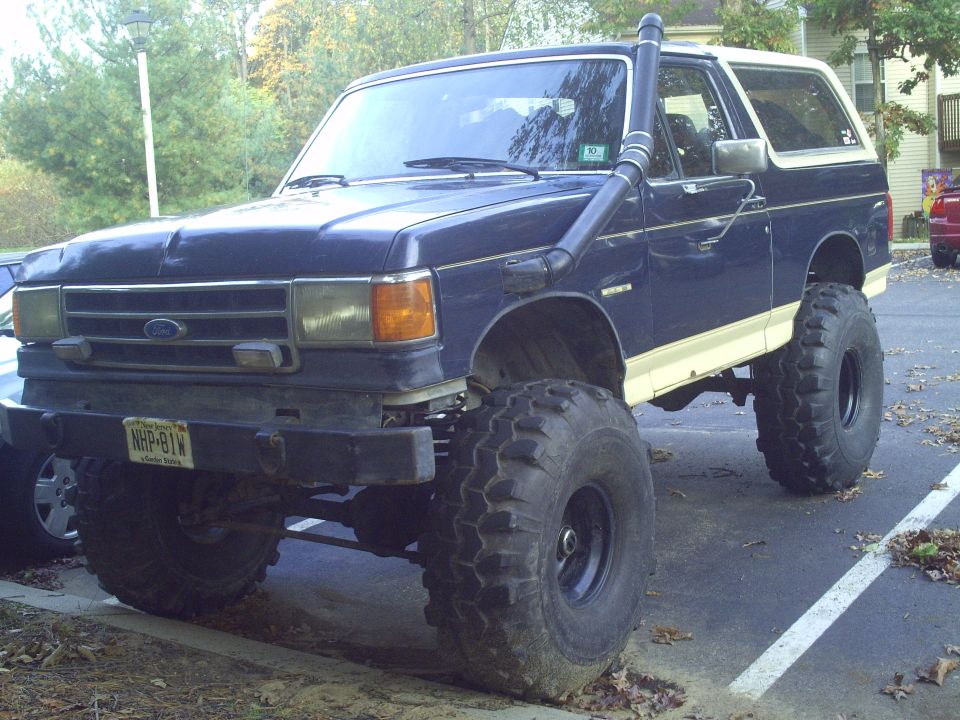 Blue 1990 Ford Bronco with snorkel and lifted suspension