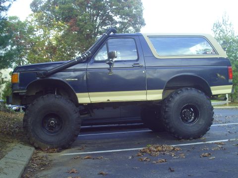 1990 Ford Bronco - This modified 1990 Ford Bronco features a snorkel and oversized tires for off-road capability.