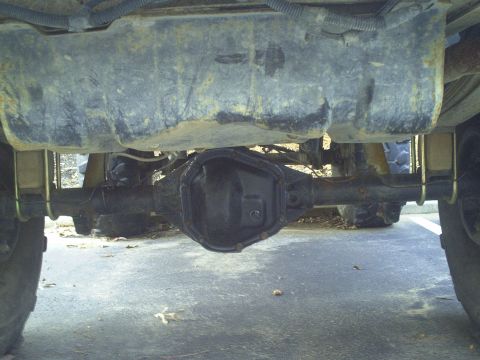 1990 Ford Bronco - Underside view of a vehicle's rear differential and fuel tank.