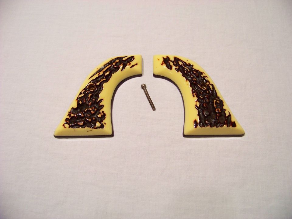 Pair of faux ivory gun grips with a screw