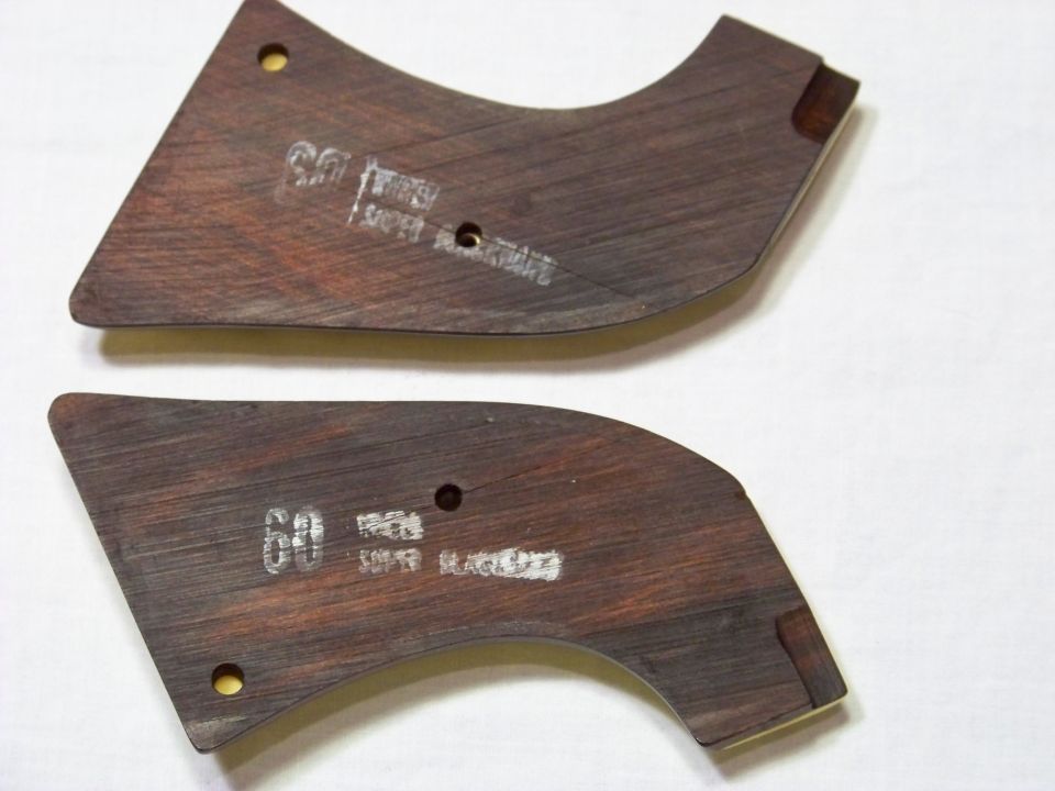 Two dark wood trim pieces with white markings that say "60" and "SUPER BLACKHAWK"