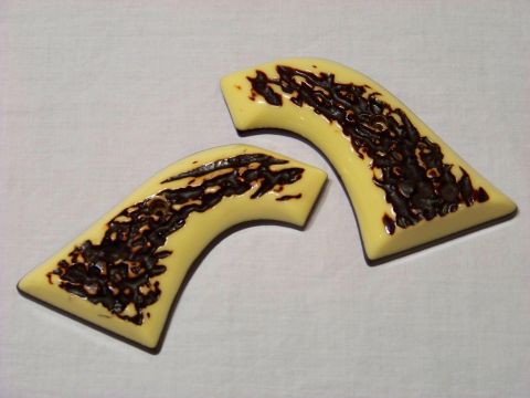 1995 Mercury Grand Marquis - Two yellow gun grips with dark brown textured inserts are displayed on a white background. The Supermotors.net logo is visible in the lower…