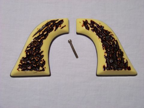 1995 Mercury Grand Marquis - Two faux ivory gun grips with a dark swirl pattern are shown with a single screw.