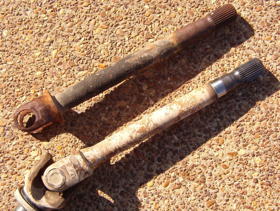 At [url=http://www.supermotors.net/registry/2742/71223-4]OCBR09[/url], I blew the caps off the U-joint in the driver's knuckle, but I didn't have a spare shaft.  A few weeks later, the front diff exploded, so I'm replacing the damaged shaft (lower) with that fine specimen of a replacement (upper) while repairing the diff.  I'm also replacing a worn upper BJ (MotorCraft MCS-10339).

Read the NEXT several captions...