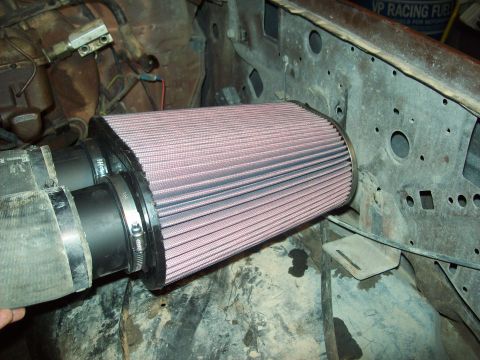 1985 Ford Bronco - Aftermarket air filter installation in an engine bay.