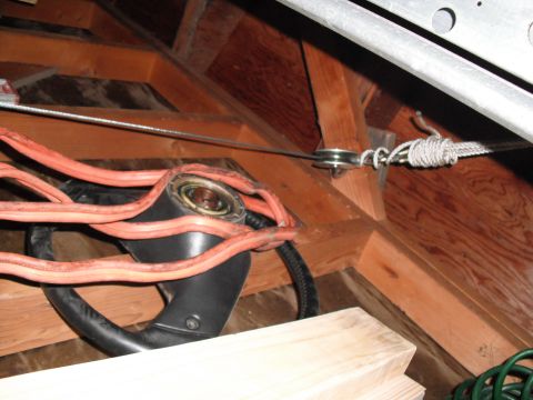 1991 Ford Bronco - The photo shows a garage door opener mechanism with orange cables and a pulley system in an attic.