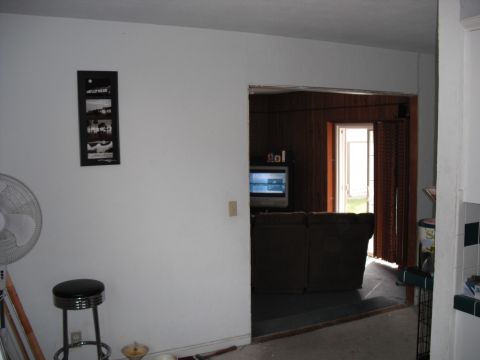 1991 Ford Bronco - An indoor scene shows a fan and stool in the foreground, with a living area visible through an open doorway.