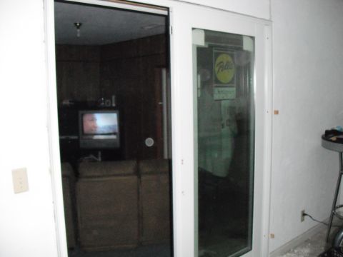 1991 Ford Bronco - View into a room with a television and furniture, seen through a glass door.