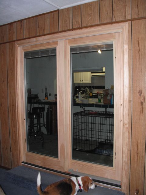 1991 Ford Bronco - View into a room through sliding glass doors, showing a kitchen and bar area, with a dog in front.