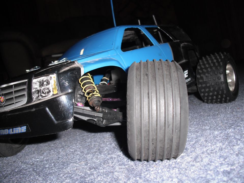 RC car with blue body and black front end, "PROLINE" text visible on bumper