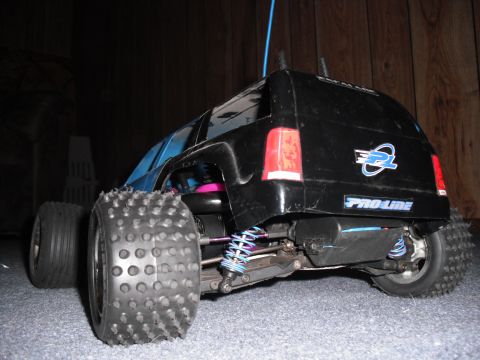 1991 Ford Bronco - This remote control car features a black body with blue accents and prominent knobby tires.