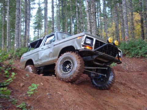 1978 Ford Bronco - This 1978 Ford Bronco navigates a challenging muddy incline on an off-road trail.