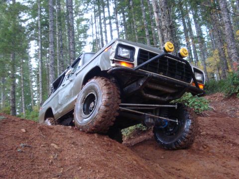 1978 Ford Bronco - This modified 1978 Ford Bronco tackles a steep, muddy incline during an off-road excursion.