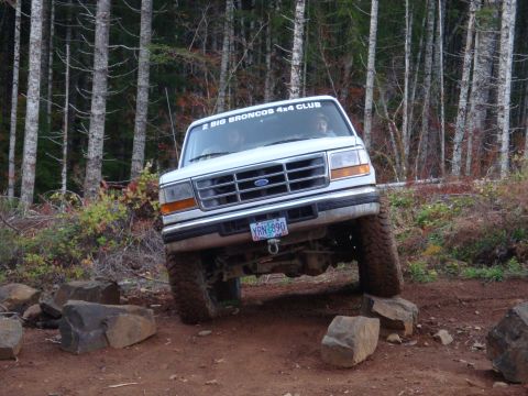 1978 Ford Bronco - This Ford Bronco is tackling a challenging off-road course, with its front tires on rocks.
