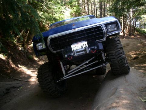 1979 Ford Bronco - This modified 1979 Ford Bronco is navigating a challenging off-road obstacle.