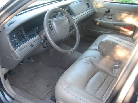 1999 Ford Crown Victoria - Interior view of a 1998 Ford Crown Victoria, highlighting the tan leather seats and dashboard details.