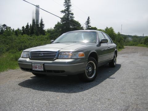 1999 Ford Crown Victoria - This 1998 Ford Crown Victoria is seen from the front 3/4 angle on a gravel road.