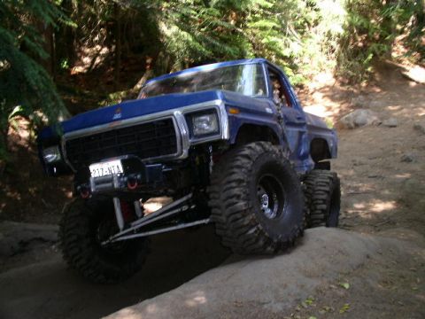 1979 Ford Bronco - This modified 1979 Ford Bronco navigates a challenging off-road course with large tires and lifted suspension.