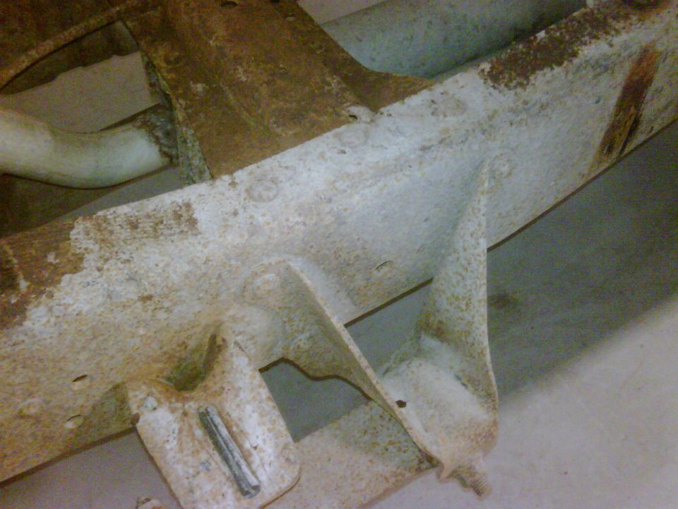 Close-up of rusty truck frame with exhaust pipe