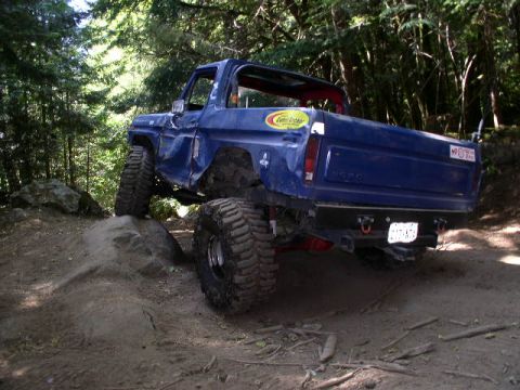1979 Ford Bronco - This heavily modified Ford Bronco is navigating a challenging off-road obstacle.