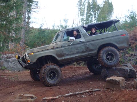 1978 Ford Bronco - A 1978 Ford Bronco navigates a rocky off-road course with two occupants inside.