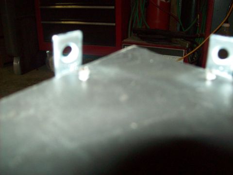 1985 Ford Bronco - A metal panel with mounting hardware is shown in a workshop setting.