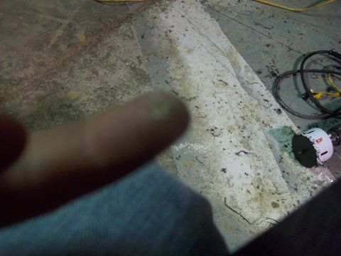 1985 Ford Bronco - Tools and a finger are visible on a dirty floor, with a website URL at the bottom right.