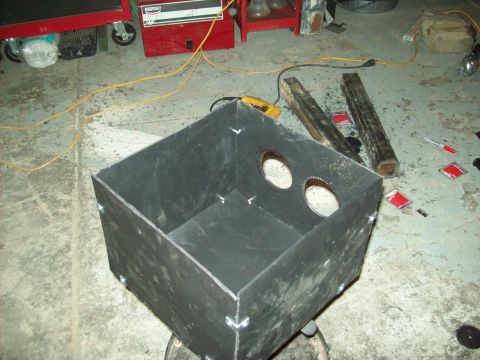 1985 Ford Bronco - A fabricated metal enclosure with circular cutouts is shown in a workshop setting.
