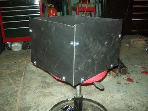 1985 Ford Bronco - A custom metal enclosure is mounted on a stool in a workshop setting.