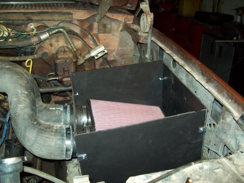 1985 Ford Bronco - Custom air intake system installed in the engine bay of a vehicle.