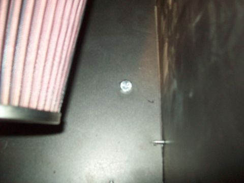 1985 Ford Bronco - A close-up view shows an air filter and a metal panel with a screw, with a watermark at the bottom right.