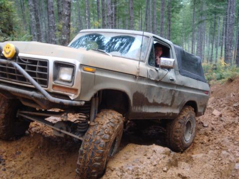1978 Ford Bronco - A 1978 Ford Bronco navigates a muddy off-road trail.