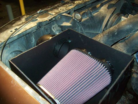 1985 Ford Bronco - Custom air intake system installed in an engine bay, a prominent K&N air filter.