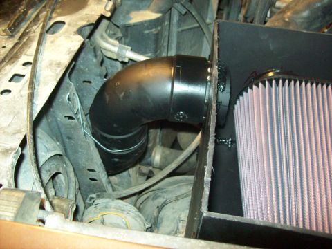 1985 Ford Bronco - Aftermarket air intake system installed in the engine bay, a large conical air filter and black piping.