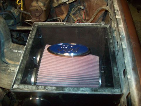 1985 Ford Bronco - Close-up of an aftermarket air filter with a Ford emblem in an engine bay.