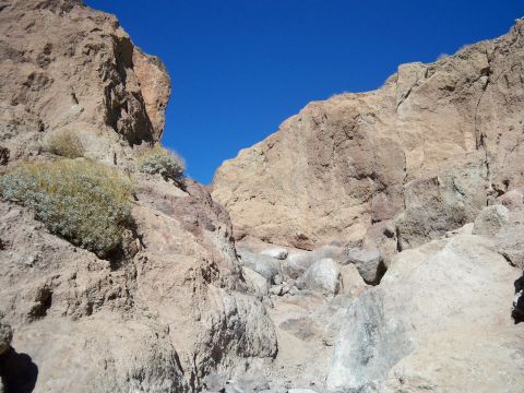 1985 Ford Bronco - A view into a rocky canyon with a bright blue sky overhead.