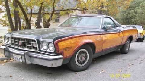 1973 Ford Ranchero - A 1972 Ford Ranchero with wood paneling is parked on a street, with another vehicle visible behind it.