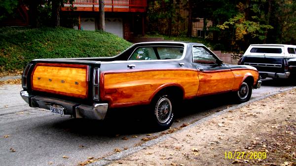 1973 Ford Ranchero with wood paneling, parked on a street next to another vehicle